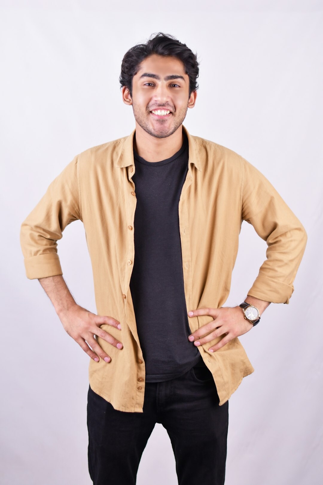 Studio portrait of a smiling man in smart casual attire